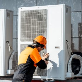 workman-installing-outdoor-unit-of-the-air-conditioner